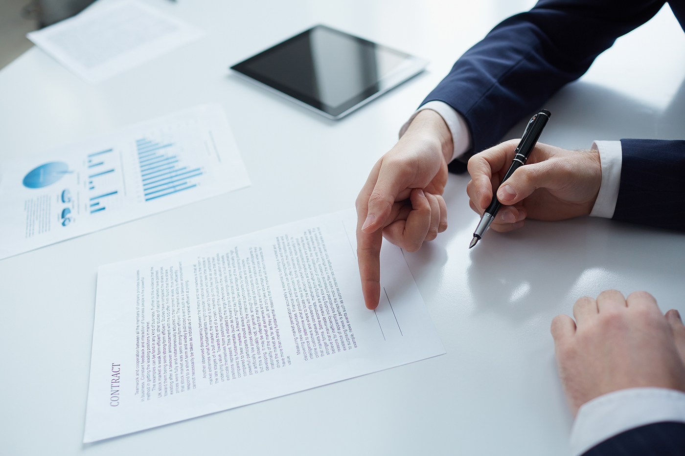 Two businessmen while signing a contract